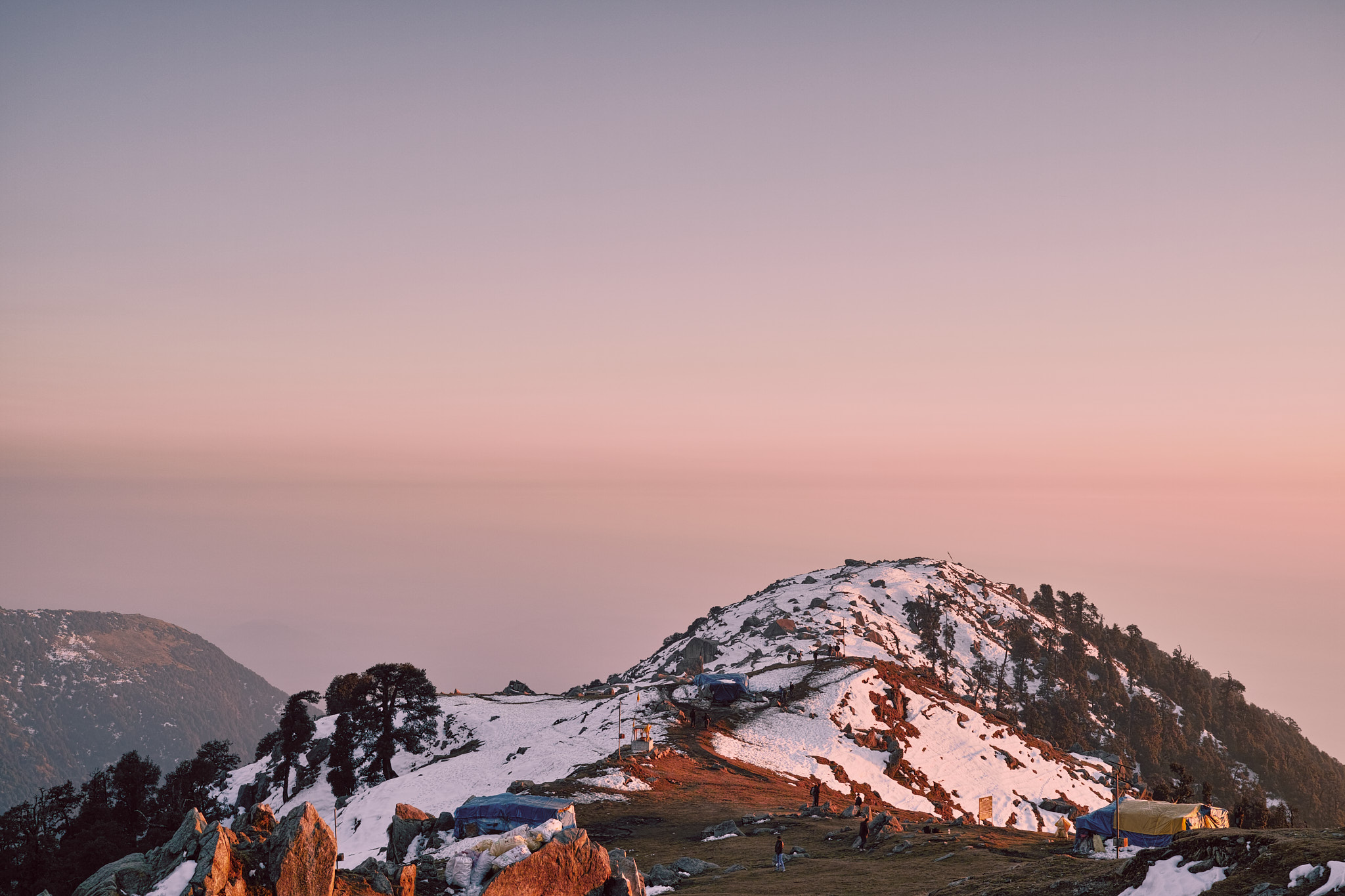 Triund with its tea shops visible on a snow covered winter morning